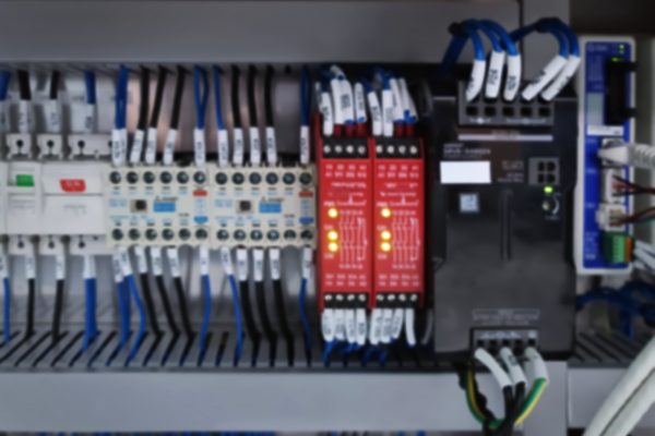 Blurred Background of Switches and Wiring Inside of Electrical Control Cabinet